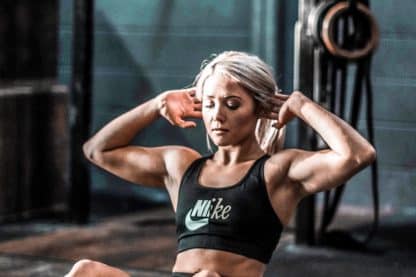 woman in black tank top and black shorts sitting on floor